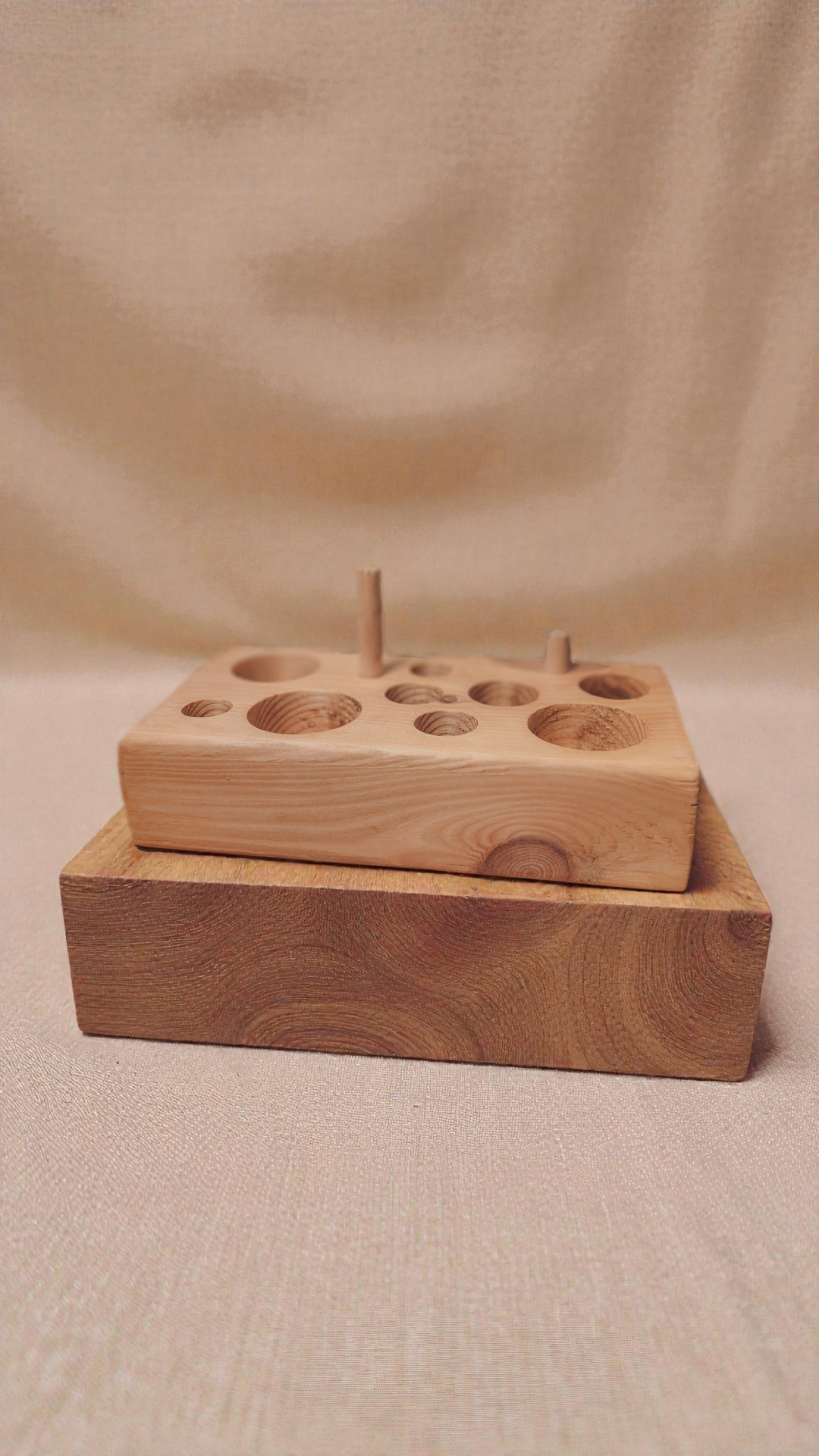 Wooden cat feeding puzzle with linen background