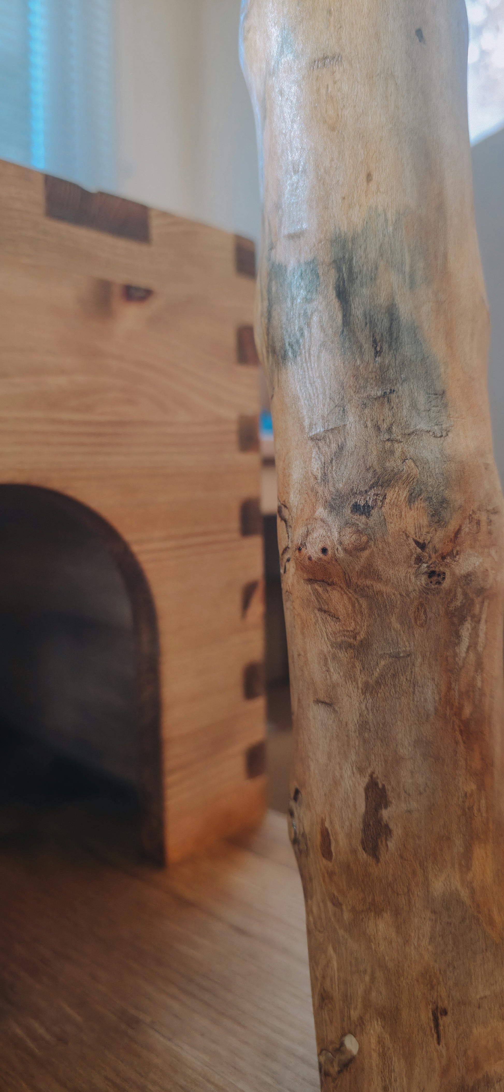Close-up of a wooden cat tree with a focus on the texture and grain.