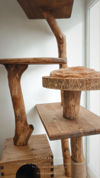 solid wood cat tree made from branches with fur pillows and hideaway