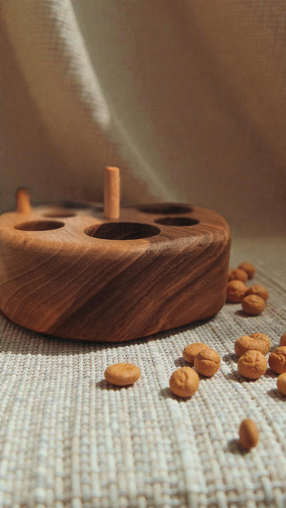 Wlnut wood cat feeding puzzle with linen background and cat kibble