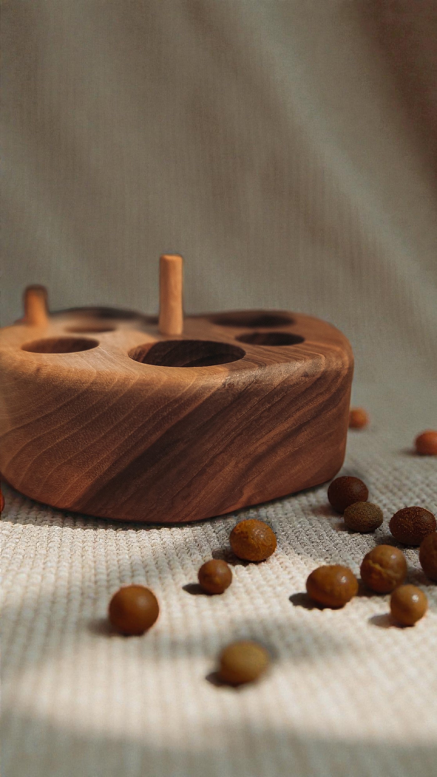 Walnut wood cat feeding puzzle and chew toy with focus on unique wood grain