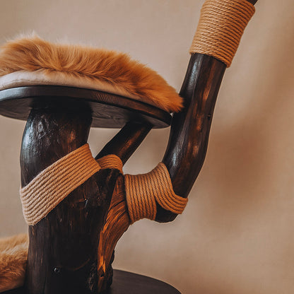 Wooden cat tree with fur cushion and rope, against a neutral background