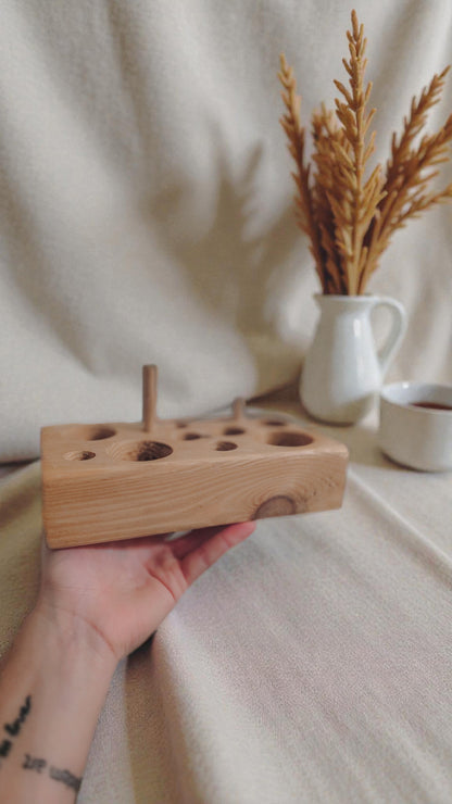 Solid wood cat feeding puzzle and chew toy in oak finish