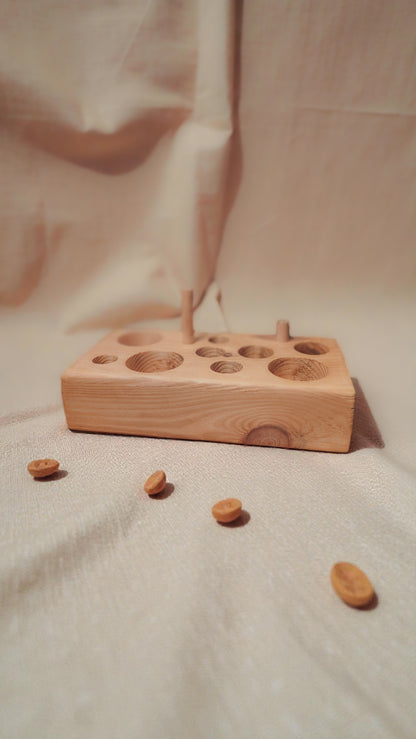 wooden cat feeding puzzle and chew toy with linen background