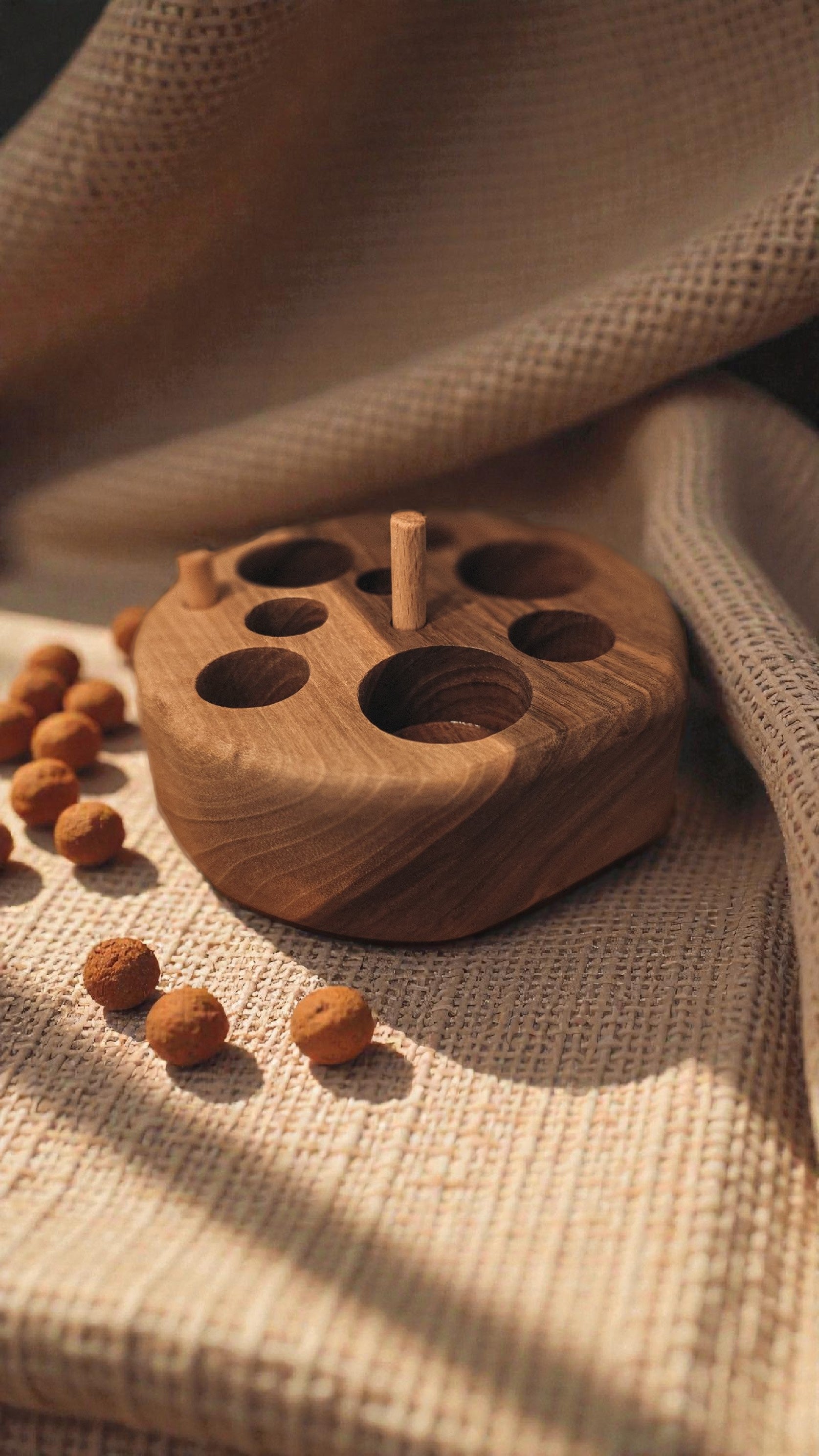 Solid wood cat feeding puzzle and chew toy with linen background interior home 