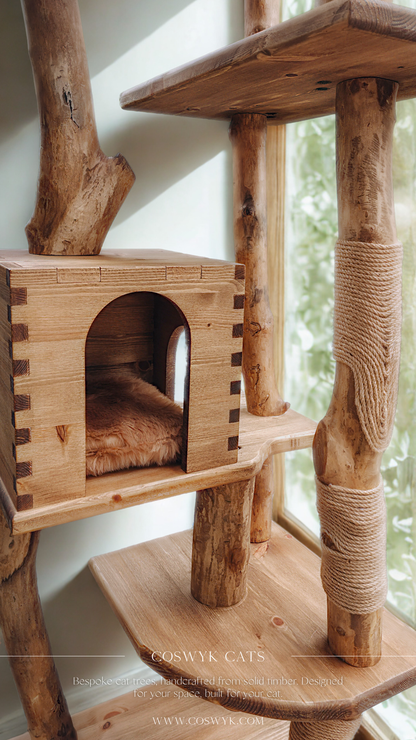 Wooden cat tree with a cozy nook and scratching post against a window.